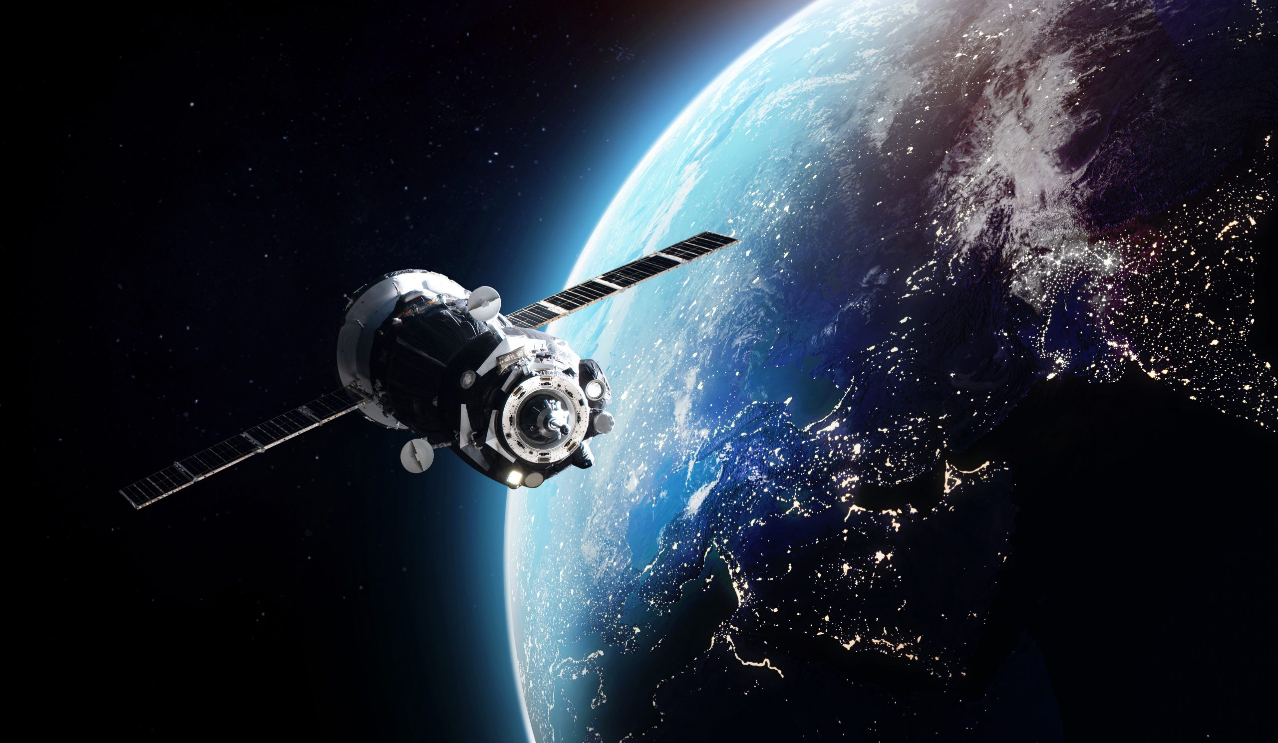 Cargo spaceship on orbit of the Earth planet. Dark space. Elements of this image furnished by NASA